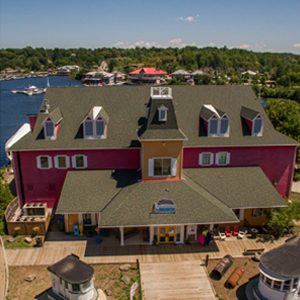 muskoka steamships and discovery centre building from drone, lake muskoka in background