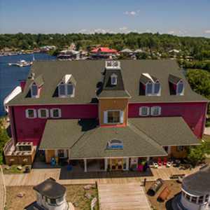 muskoka steamships and discovery centre building from drone, lake muskoka in background