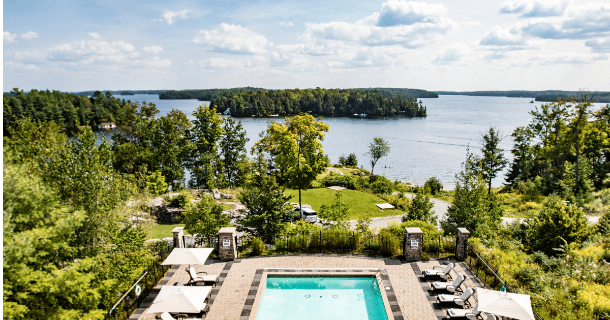 Resort pool over looking lake rosseau ontario during the summer