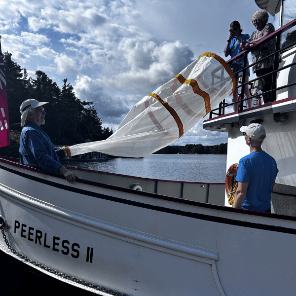 image of people hold net on boat